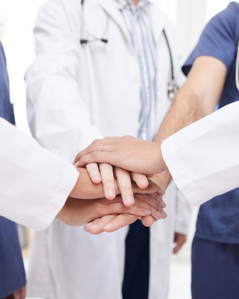 Doctor,,Teamwork,And,Hands,Together,In,Meeting,,Motivation,Or,Unity